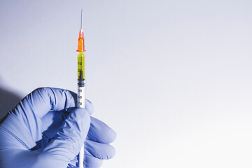 Syringe held by a gloved hand