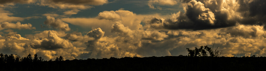 Obraz na płótnie Canvas Large panorama of sunset clouds in orange, nature