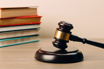 Judge gavel and laws books on a wooden table.