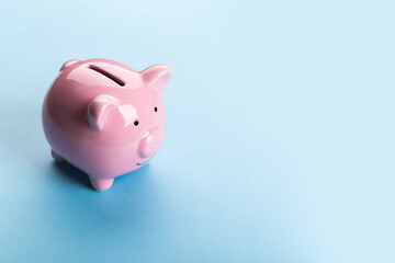 pink piggy bank on blue background.  The concept of saving money or savings, investment