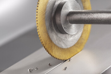 End mill cutting aluminium billet. Circular milling machine make hole in metal profile.