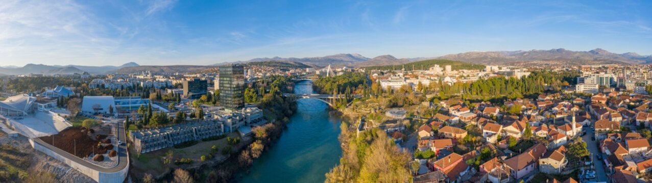 Turquoise Moraca river flowing through downtown Podgorica in Montenegro on a sunny afternoon. Old town (Stara Varos) with red roofs.