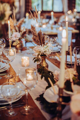 Fototapeta na wymiar rustic wedding decorations with flowers and candles. banquet decor. picture with soft focus