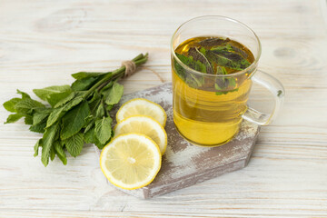Mint tea with lemon wedge, healthy and delicious drink