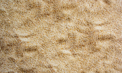 Light beige sand texture on a sunny day