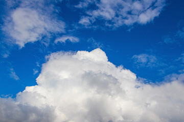 Naklejka na ściany i meble Big curly white cloud in the blue sky