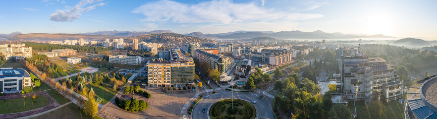 Podgorica, Montenegro in the morning, shortly after sunrise. Aerial view of the new commercial and residential district. Autumn in the green city. 