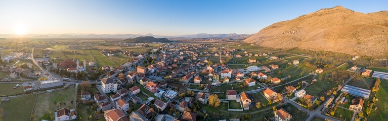 Fototapeta na wymiar Tuzi, the youngest municipality in Montenegro, in the afternoon, close to sunset. Center of Malesi e Madhe District, populated mainly by Malisors. Situated at the foot of Decic hill. Aerial shot.