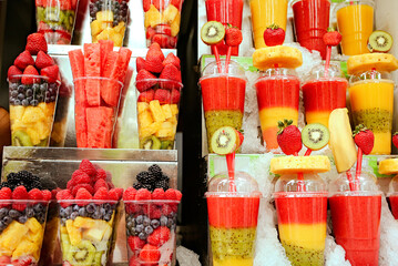 Smoothie fruit delicious and healthy dessert in plastic cups for tourists in Prague, Czech Republic, Europe. Snack fruit. The concept of vegetarians and healthy eating.