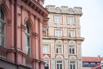 Fototapeta na wymiar Typical Austro-Hungarian Facade of a baroque appartment residential building in a street of old town, the historical center of Prague, Czech Republic, in the most touristic part of the city