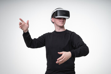 European man with dark hair wears 360 goggles which covers almost all his face, he gesticulates and touches air around