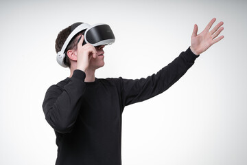 Side view portrait of a man in VR glasses, pointing up with his hand