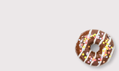 Glazed chocolate donut with sprinkles on a white background
