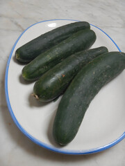 A dish with four cucumbers