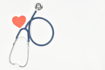 Fototapeta premium Top view of heart and stethoscope for medical check up on white background. copy space.