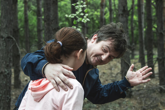 A teenage girl is talking in the woods with a man who offers to go with her. The concept of kidnapping.