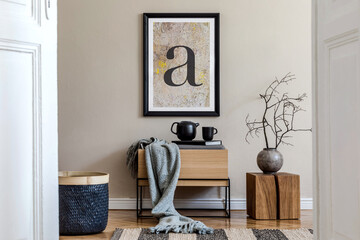 Modern scandinavian living room interior with black mock up poster frame, design commode, dried flower in vase, black rattan basket, books and elegant accessories. Template.