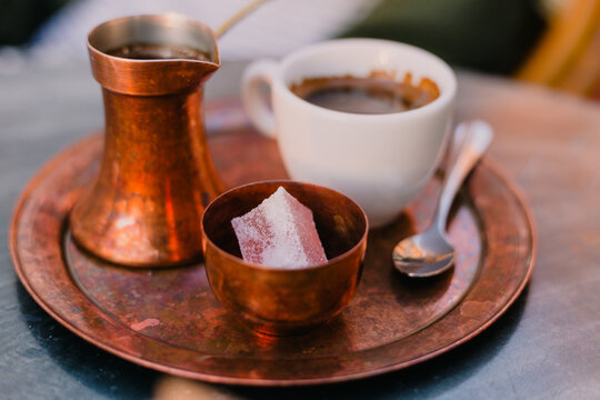 Traditional Arabic coffee served on copper metal plate. Kahveni takum.