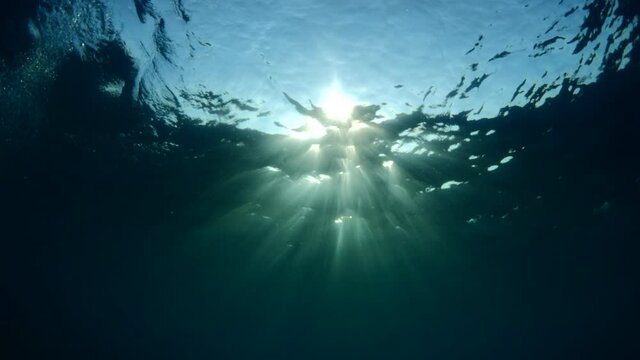 sun ray and sun beam scenery underwater waves on surface of water slow ocean scenery