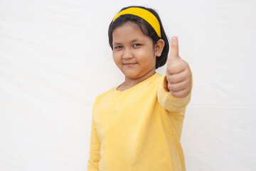 Portrait Of Girl giving thumbs up
