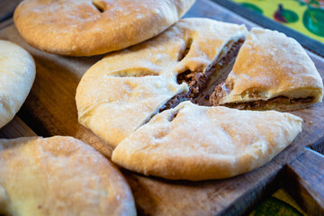 Lobiani, traditional Georgian flatbread with red beans stuffing, close-up with selective focus. Lobiani is a popular baked dish in Georgia.