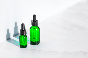 Natural cosmetics serum, extracts and oils for skin and hair care in a bottle with a pipette. The concept of organic herbal cosmetics for beauty.