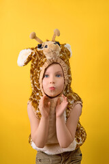 Close-up portrait of a cute little girl. Studio shot over yellow background. Childhood concept.