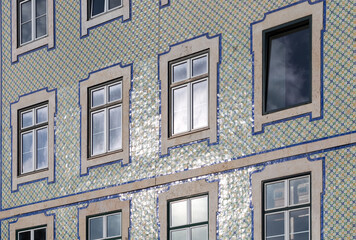 Azulejo - Portuguese and Spanish painted tin-glazed ceramic tiles - on the facade of a residential...