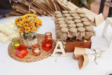 A festive table setting with Beautiful carafe with lemonade and a lot of sweets: muffins, lemonade,...