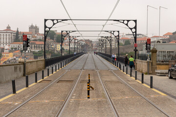 Naklejka premium View from the Dom Luiz I Bridge, rails of the city metro. People walk at Dom Luis bridge, Porto, Portugal.