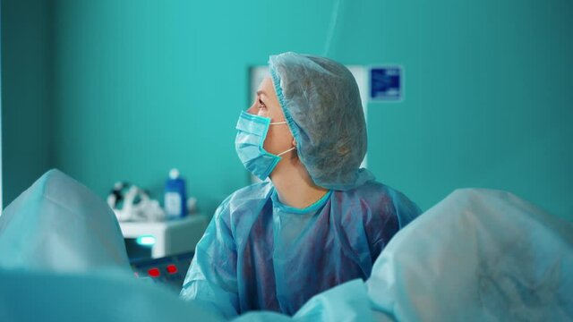 Process of gynecological operation. Young woman lying in gynecological chair during gynecological checkup with her doctor