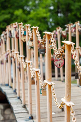 Lots of metal locks on a chain, heart in focus
