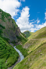 Naklejka premium Truso Valley and Gorge trekking / hiking route landscape, in Kazbegi, Georgia. Truso valley is a scenic trekking route close to the border of North Ossetia.