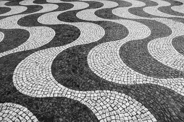 Wave pattern Portuguese pavement on Rossio (King Pedro IV) square (Praca) in Lisbon Portugal....