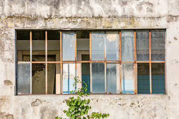 Fototapeta na wymiar Cityscape. View of abandoned factory building: broken windows