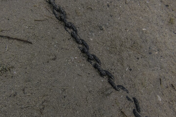 chain at the bottom of a lake in the sand while diving