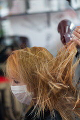 woman drying hair in a hairdressing