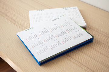 Calendar page close up on wood table background business planning appointment meeting concept