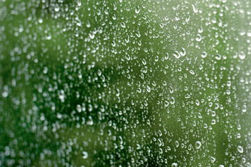 home window with raindrops after summer rain