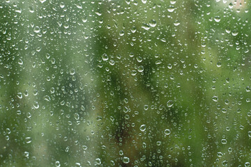 home window with raindrops after summer rain