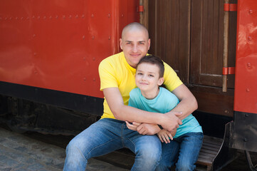 dad hugs his son on a walk. Warm kind family photo