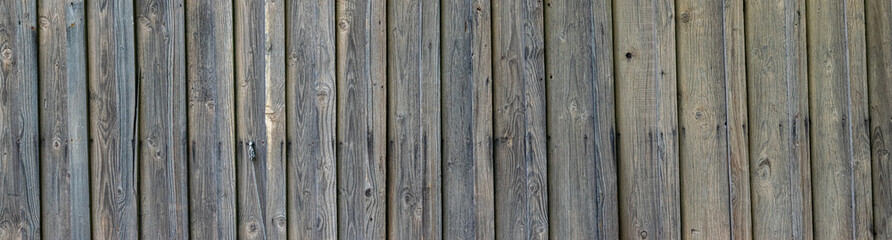 panorama of the surface of wooden boards. Gray wooden fence.