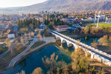 Danilovgrad Montenegro: bridge on Zeta river on the way to Ostrog monastery and the downtown park. Aerial view of the small town in Bjelopavlici.