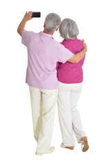 Senior couple taking selfie isolated on white background