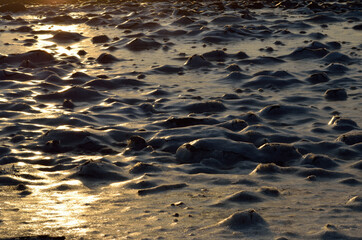 morning sun reflection on deep frozen sea shore background