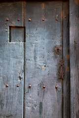 Spanish old rustic wooden door painted in gray