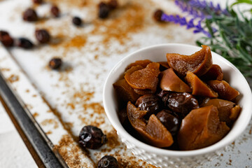Sweet and soft dried Apple and rose hips prepared for dessert, decorated with a sprig of lavender and dry fruits on an unusual white and rusty metal background