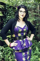 Young woman wearing glasses posing in vintage style dress