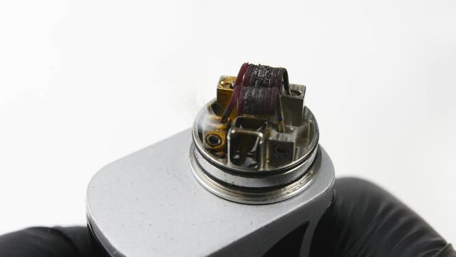 Vaping atomizer with clapton coil is working. Vape device or cigarette.