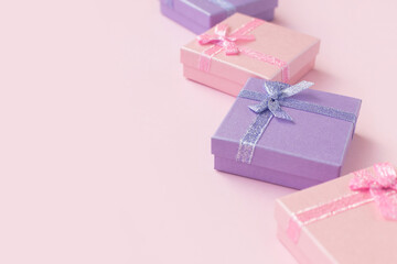 Pink and purple gift boxes on pink background close up. Shopping sale concept 